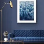 ‘Deep Blue Sea’ framed above a minimalist sofa in a modern living room, highlighting the textured ocean waves and foam details.