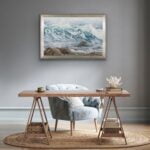 Original watercolor painting of ocean waves framed above a desk in a home working space, bringing tranquility and a coastal ambiance to the office environment. Perfect for adding a serene touch to a productive setting.