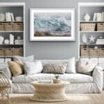 Original watercolor painting of ocean waves framed above the sofa in a coastal living room, adding a serene and tranquil atmosphere with shades of blue. Perfect for coastal home decor.