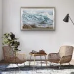 Original watercolor ocean wave painting framed in a modern living room, adding a tranquil coastal atmosphere to the space.
