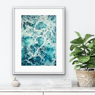 Framed seascape 'My Heart Belongs to the Sea' above a minimalist shelf, bringing tranquility to the space.