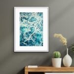 Framed 'My Heart Belongs to the Sea' displayed above a minimalist wooden shelf, paired with nautical decor for a calming coastal touch.