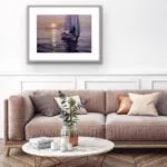 Framed "Calmness" ocean watercolor painting displayed above a sofa, enhancing tranquil coastal living spaces.