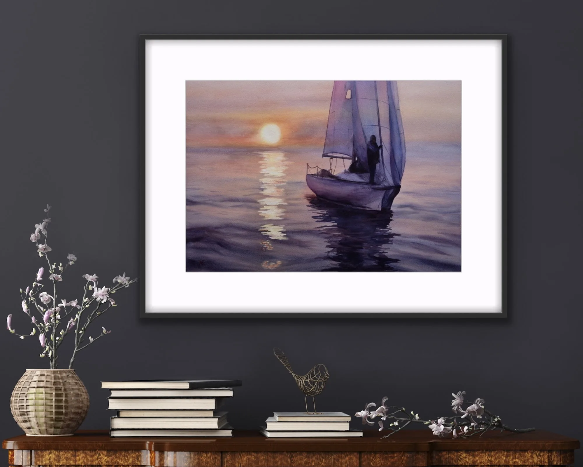 "Calmness" sailboat watercolor art elegantly placed above a wooden commode, adding peaceful ocean-inspired decor.
