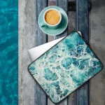 Protective laptop sleeve with 'My Heart Belongs to the Sea' artwork, showcasing serene seascape design in soft blue tones for nautical-themed accessories.