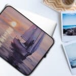 "Calmness" watercolor sailboat painting printed on a sleek laptop case, featuring a serene yacht on sunset waters—perfect nautical accessory for coastal style lovers. Durable, lightweight, and designed for ocean-inspired protection.