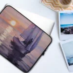 "Calmness" watercolor sailboat painting printed on a sleek laptop case, featuring a serene yacht on sunset waters—perfect nautical accessory for coastal style lovers. Durable, lightweight, and designed for ocean-inspired protection.