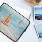 Protective laptop case with ‘Orange Sail’ artwork, ideal for coastal decor enthusiasts looking for unique and vibrant nautical laptop accessories.