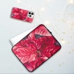 Holiday-themed iPhone and laptop cases featuring a vibrant red poinsettia watercolor painting, perfect for festive decor and seasonal style.