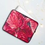 Elegant red poinsettia watercolor art on laptop case, perfect for adding holiday cheer to your device.