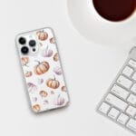 Festive Halloween-themed clear iPhone case with a unique orange pumpkin pattern in soft watercolor tones.