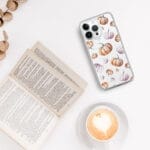 Autumn-themed clear iPhone case with vibrant watercolor orange pumpkin pattern, ideal for festive seasonal decor.