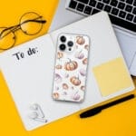 Charming orange pumpkin pattern in watercolor art featured on a clear iPhone case, perfect for fall and Thanksgiving aesthetics.