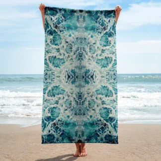 Beach Towel with an abstract print of the blue and green ocean water