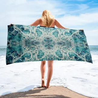Beach Towel with an abstract print of the blue and green ocean water