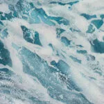 Close-up of ocean wave in soft blue hues, highlighting the tranquility of the watercolor seascape.