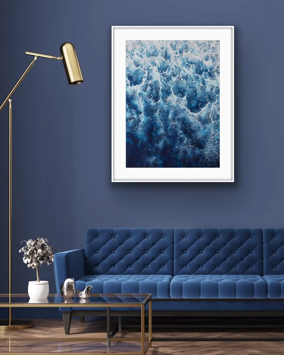 Framed ‘Deep Blue Sea’ in a serene blue colored living room, featuring abstract ocean waves and foam to enhance relaxation.