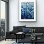 Modern living room with framed ‘Deep Blue Sea’ abstract ocean painting, emphasizing foam and dynamic wave movement.
