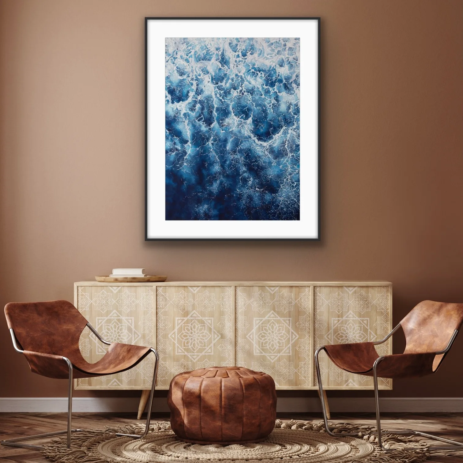 Framed ‘Deep Blue Sea’ seascape in a coastal home, bringing abstract ocean waves and foam to the living room.