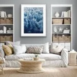 Framed ‘Deep Blue Sea’ painting displayed above a sofa in a coastal living room, showcasing dynamic waves with foam.