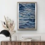 Framed "Evening Mood" watercolor seascape above the commode, bringing a tranquil ocean scene into a cozy interior space