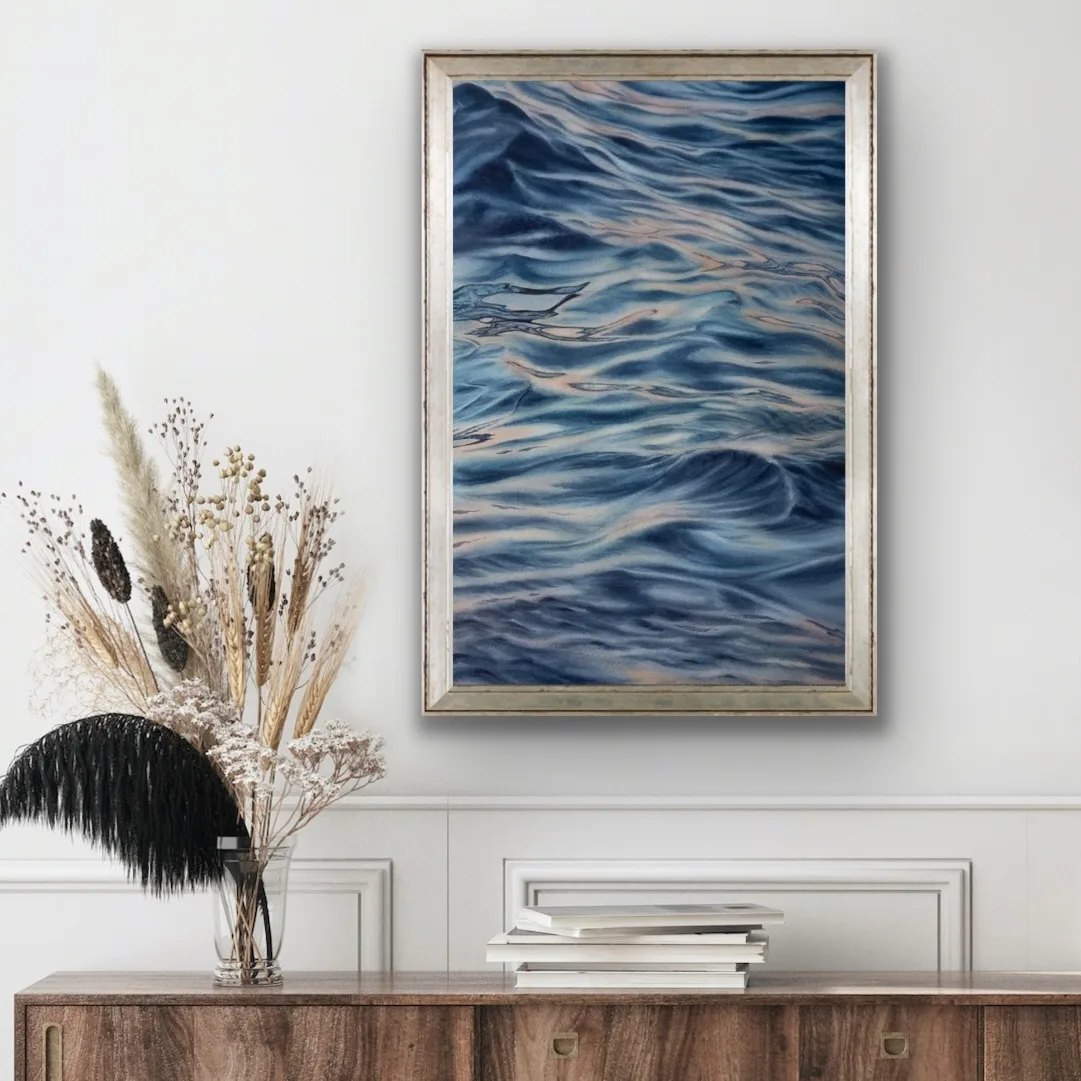 Framed "Evening Mood" watercolor seascape above the commode, bringing a tranquil ocean scene into a cozy interior space
