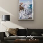 Framed ‘Breaking Wave’ ocean painting in a modern living room above a black sofa.