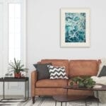 'My Heart Belongs to the Sea' framed above a living room sofa, enhancing coastal home decor with its calming ocean tones.