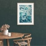 Kateryna Nazarenko’s ocean artwork in a contemporary dining room, adding a touch of the sea.