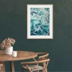 Kateryna Nazarenko’s ocean artwork in a contemporary dining room, adding a touch of the sea.
