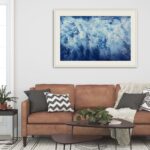 Tranquil blue seascape 'Ocean Blues' in a coastal-themed living room with neutral tones.