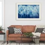 Tranquil blue seascape 'Ocean Blues' in a coastal-themed living room with neutral tones.