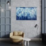 Abstract ocean painting 'Ocean Blues' displayed in a contemporary living room with soft lighting.