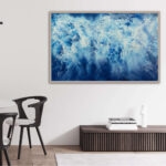 Framed 'Ocean Blues' seascape art in a contemporary dining room with natural wood accents.
