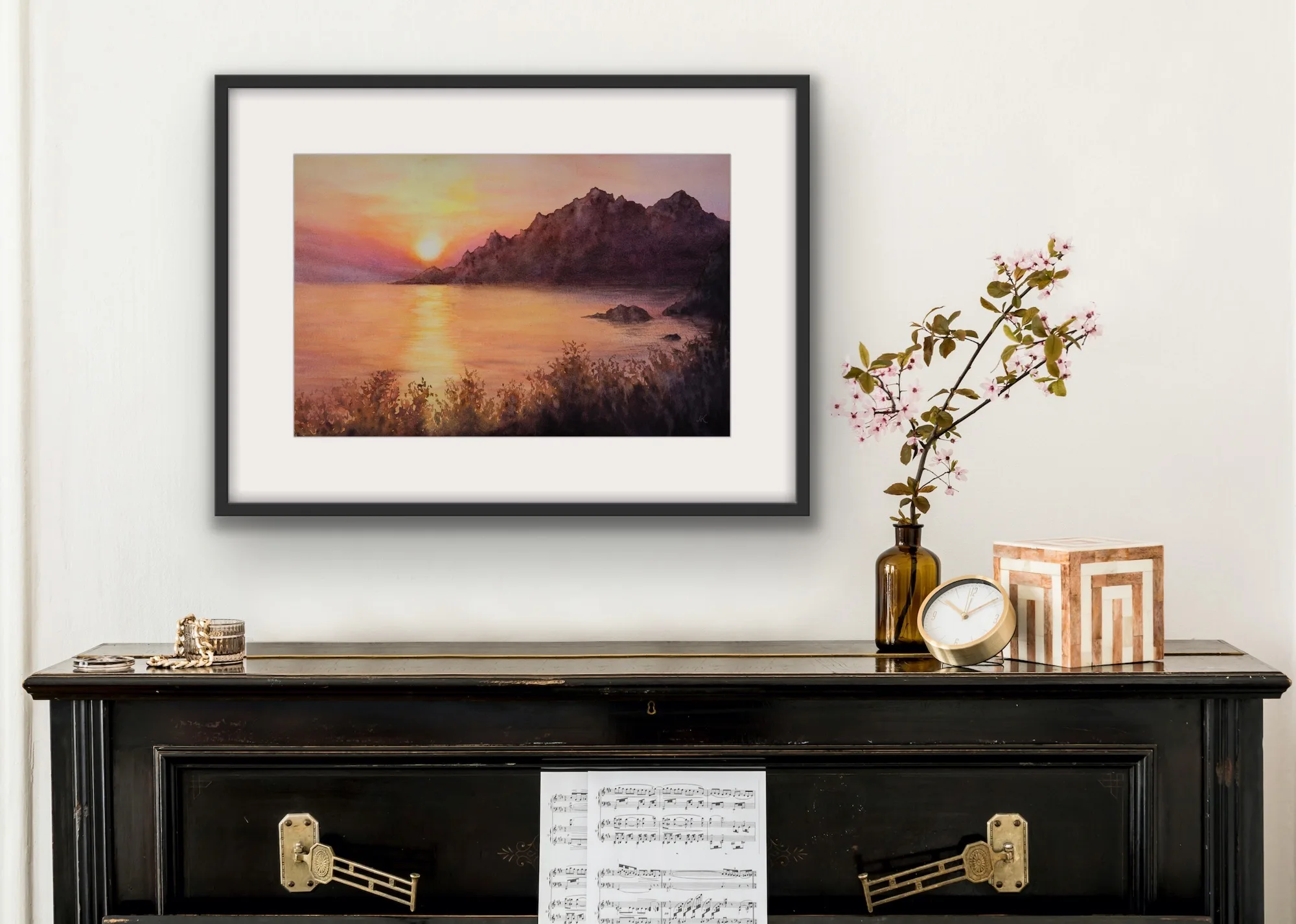 This Corsican seascape hung on the wall, capturing the beauty of a Mediterranean sunset.