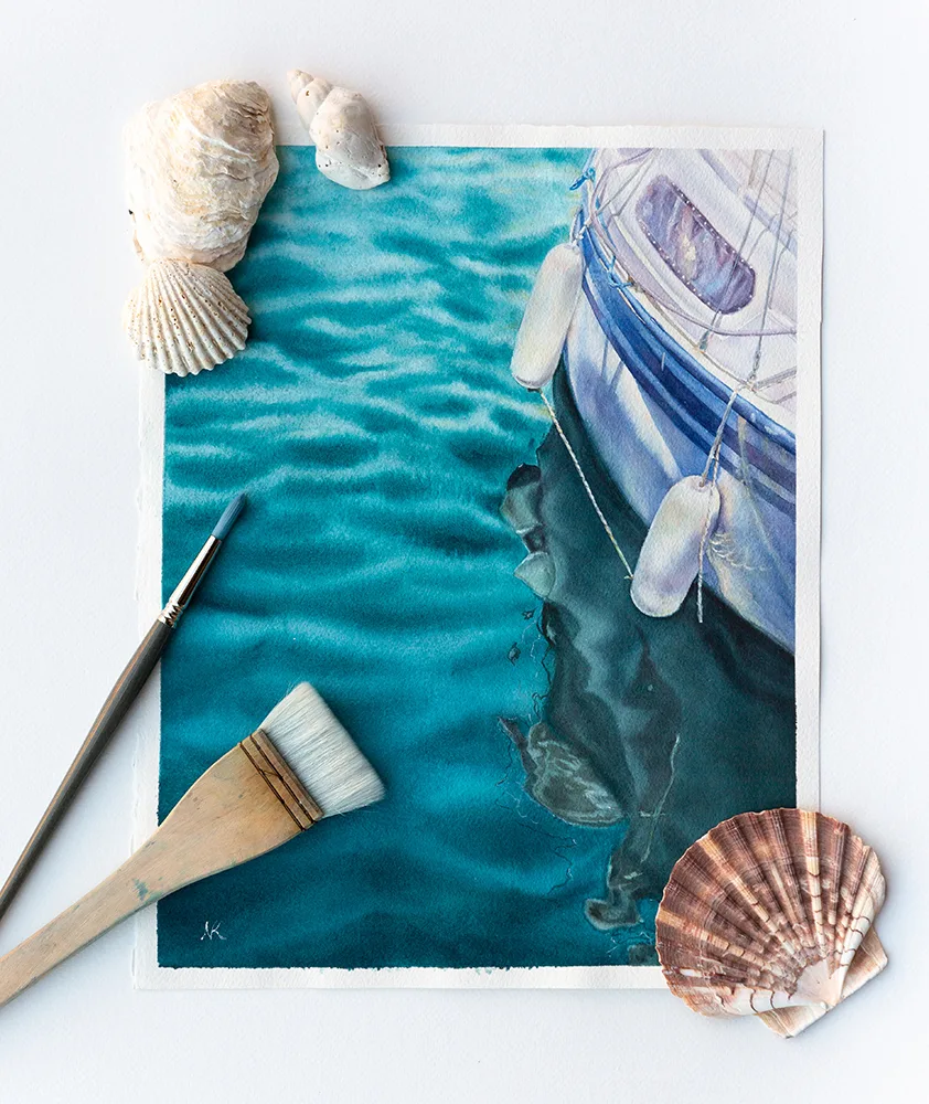 "Summer Memories" watercolor painting of a yacht on calm green waters, resting on artist's table, bringing a tranquil coastal vibe with its serene seascape and soft hues of the ocean.
