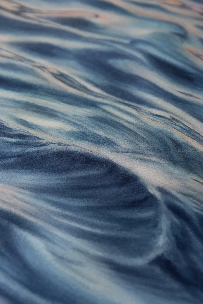 Close-up of soft grays and muted blues blending in "Evening Mood," showcasing the tranquil movement and depth of the ocean's surface