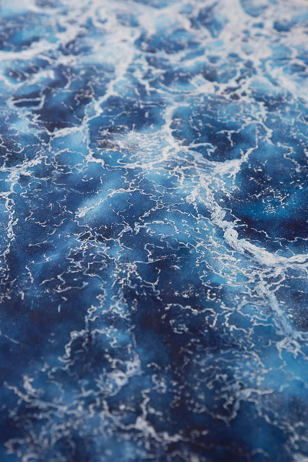 Closeup of the powerful waves and foam in ‘Deep Blue Sea’ abstract ocean painting, showcasing the intricate texture and depth of the ocean scene.