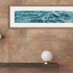 'Sparkles on Turquoise Water' framed in a hallway, inviting serenity and ocean-inspired tranquility to guests as they enter.