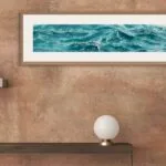 'Sparkles on Turquoise Water' framed in a hallway, inviting serenity and ocean-inspired tranquility to guests as they enter.