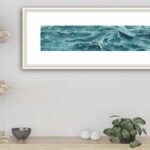 'Sparkles on Turquoise Water' framed above a counter in a coastal kitchen, capturing the tranquil beauty of the ocean.