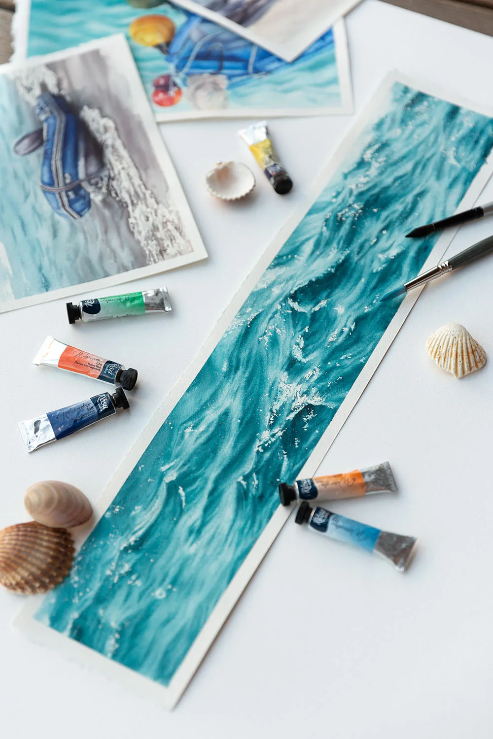 Close-up of 'Sparkles on Turquoise Water' being painted on a studio table, capturing delicate brushstrokes and shimmering layers of turquoise hues in the creative process.