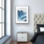 Framed ‘Night Wave’ in a serene bedroom setting, creating a bold contrast against neutral decor with its deep, energetic ocean waves.