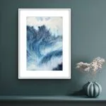Framed ‘Night Wave’ above a shelf in a modern living room, adding a dynamic coastal touch with its dramatic navy blue ocean waves and powerful energy.