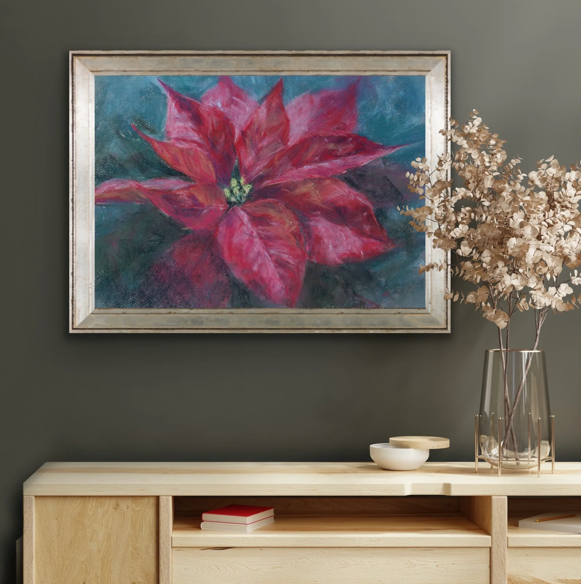 Framed red poinsettia soft pastel painting displayed on a wall, adding elegant holiday charm.