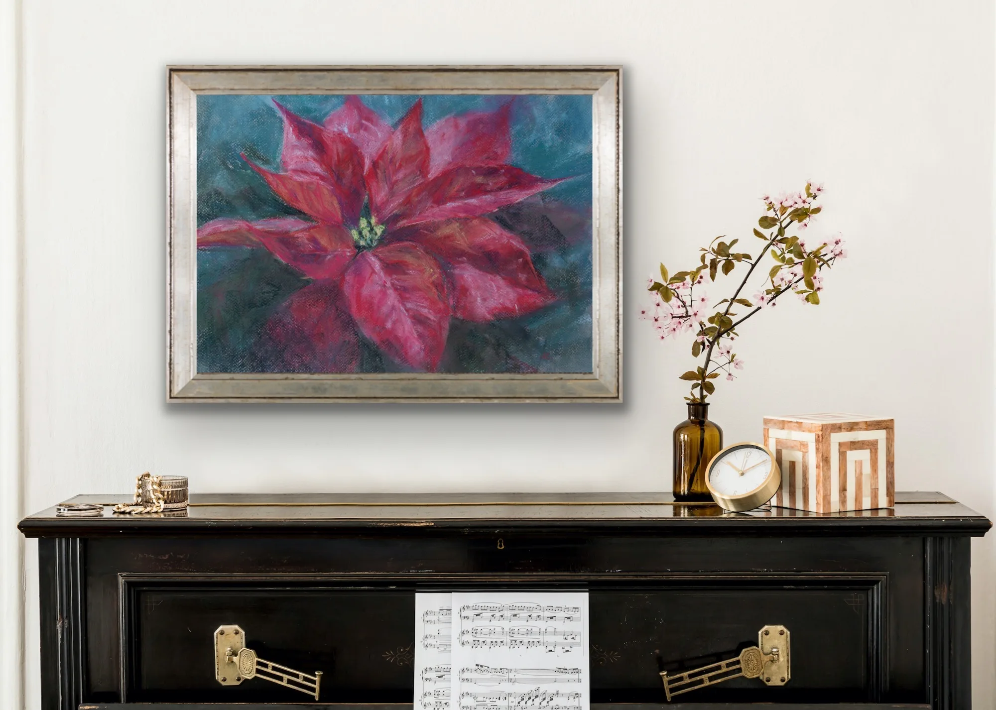 Red poinsettia soft pastel painting displayed above a piano, enhancing the space with vibrant holiday colors and elegance.