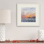 Framed ‘Sunset by the Sea’ in a modern house, bringing the tranquil ocean sunset scene to the home’s decor.