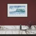 Framed ‘Coastal Wave’ in a modern dining area, bringing a touch of coastal elegance and vibrant ocean waves to the room.
