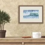‘Coastal Wave’ framed in a modern living room, bringing the beauty of ocean waves and tranquil coastal scenery to a contemporary space.