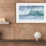 ‘Coastal Wave’ framed and displayed in a stylish home office, adding a serene ocean scene to the decor with vibrant blues and greens.